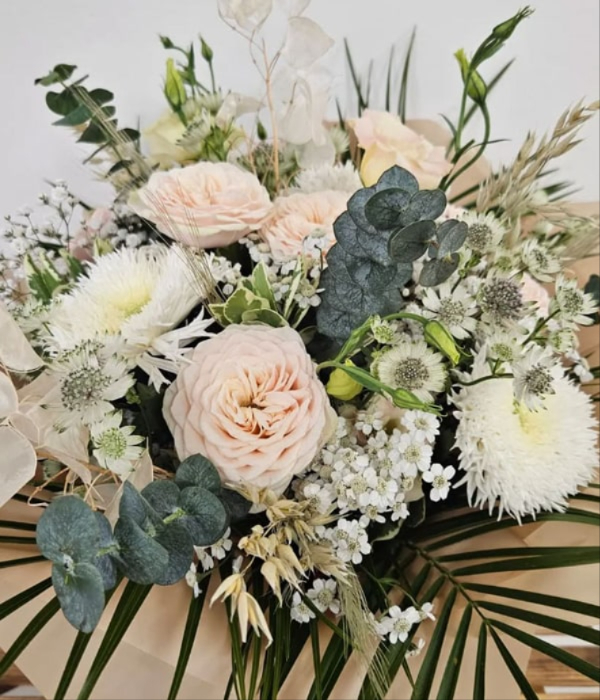 Close-up bouquet of pastel flowers including roses and chrysanthemums